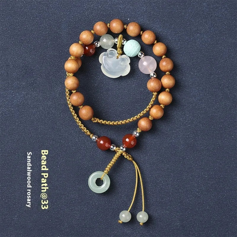 Women's ebony hand-woven double ring bracelet with Ruyi motif, available in Xiuyan jade colour