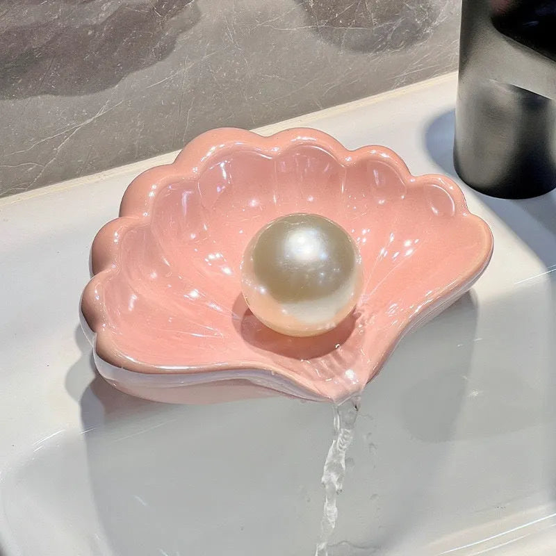Plastic shell soap dish in Pearl White or Cherry Blossom Pink measuring 12x9x5.5cm for bathroom use