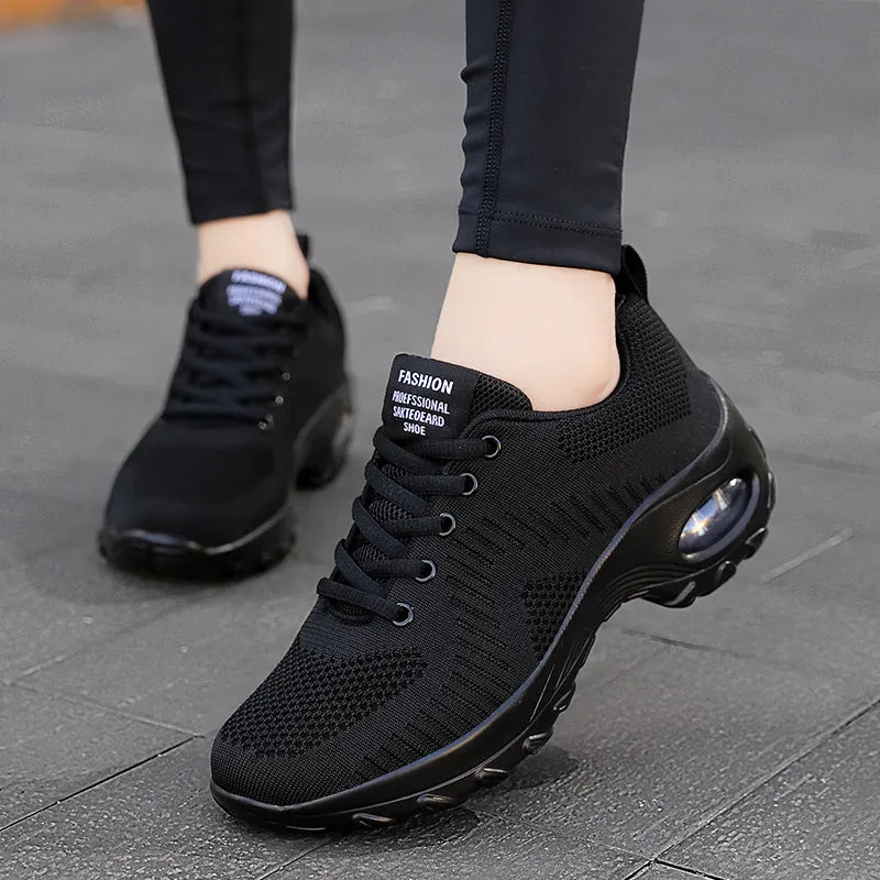 Women's round toe black mesh sneakers with white laces on a flat PU sole.