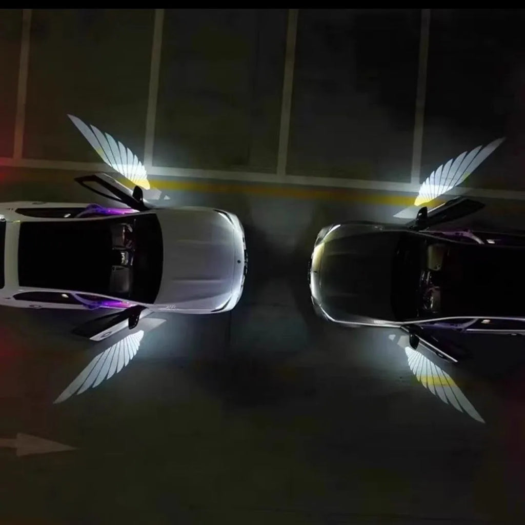 Car rearview mirror courtesy lamp projecting white angel wings light onto ground near vehicle door