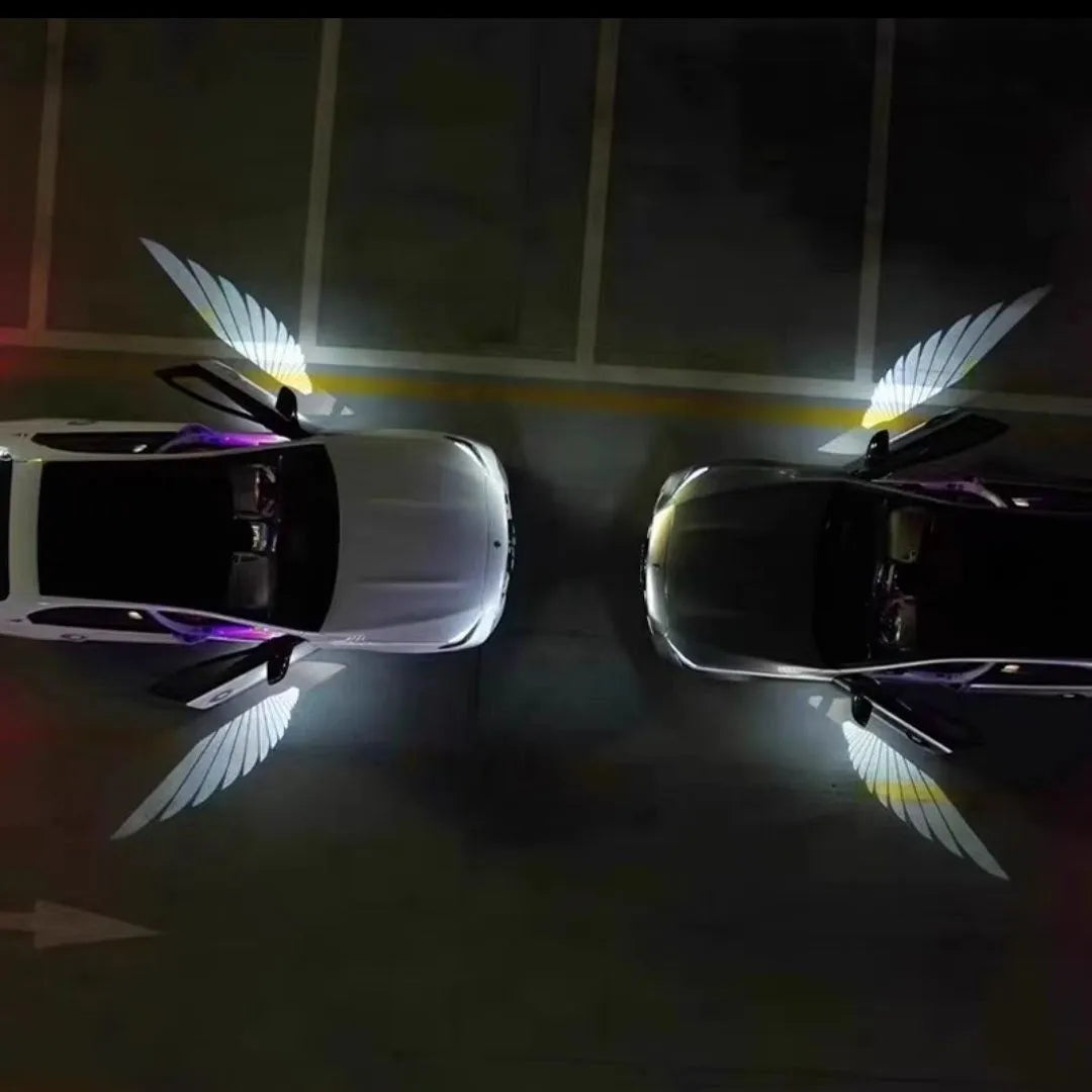 Car rearview mirror courtesy lamp projecting white angel wings light onto ground near vehicle door