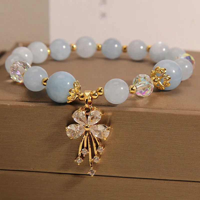 Unisex crystal bead bracelet in aquamarine butterfly colour on neutral background