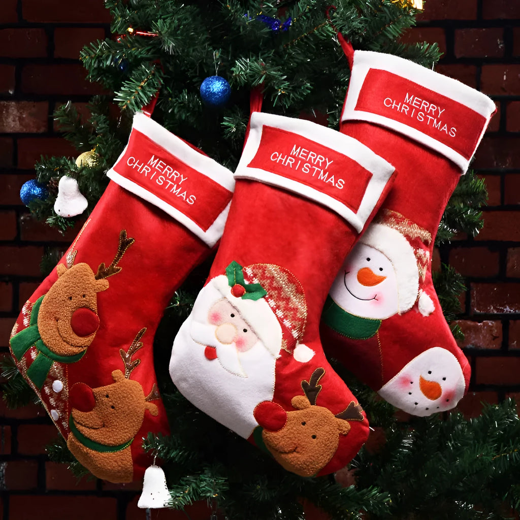 Three Christmas stocking ornaments showing elk, elderly gentleman and snowman designs in American folk art style