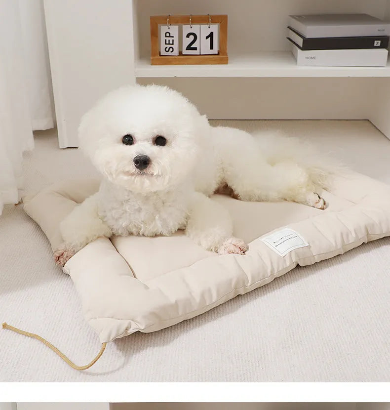 Tied cage cushion for dogs and cats in beige, showing platform attached to wire crate bars – size L.
