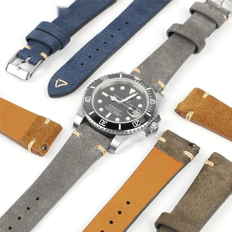 Brown genuine suede leather watch strap showing textured surface and buckle, laid flat.