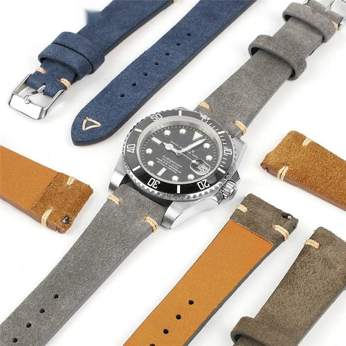 Brown genuine suede leather watch strap showing textured surface and buckle, laid flat.