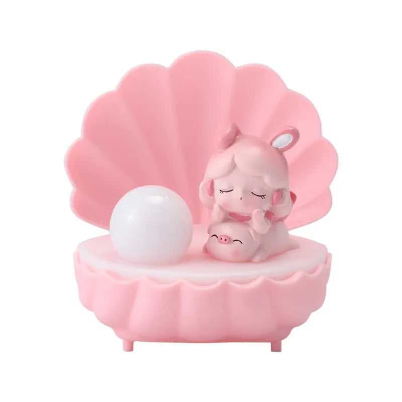 Cartoon resin small night lamp in pink pig girl colour on a bedside table