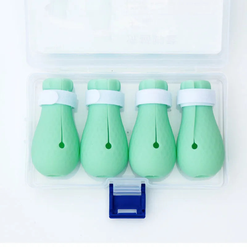 Four green silicone cat foot covers for scratch protection during pet washing and medicine administration