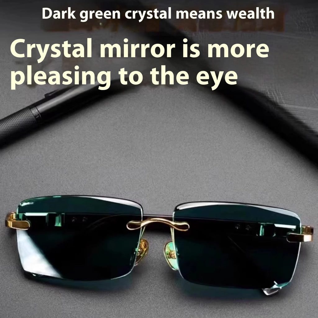 Dark green frameless crystal sunglasses with a distinctive design, shown with a hard case and lens cloth.