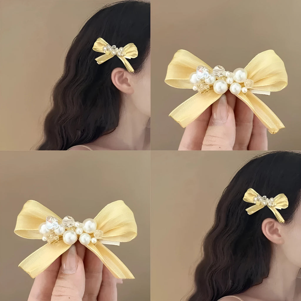 Yellow bow barrette with rhinestone and pearl on plastic duckbill clip for women