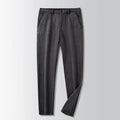 British retro style straight-leg striped trousers in a neutral colour on a hanger.
