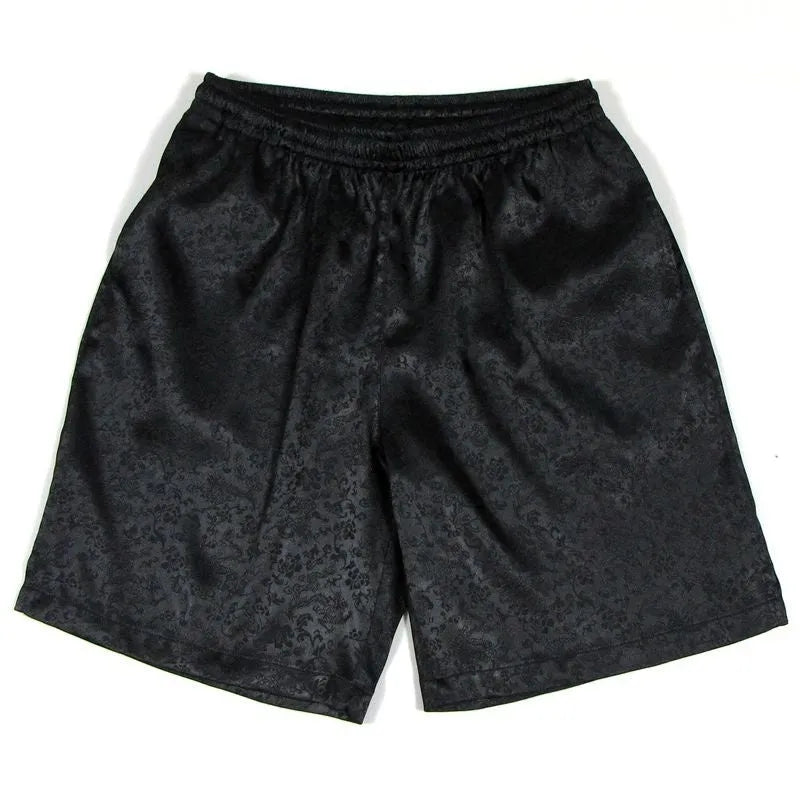 Man wearing traditional black Tang suit shorts with an elastic drawstring waistband for Tai Chi practice.