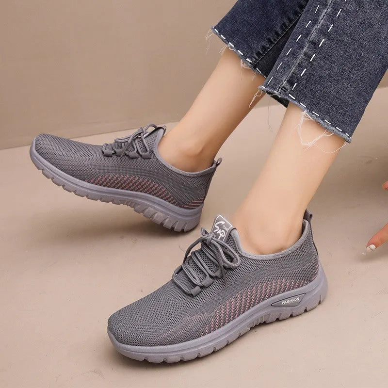 Women's breathable mesh lace-up sneakers with cross straps, round toe, and low heel in black, gray, and purple