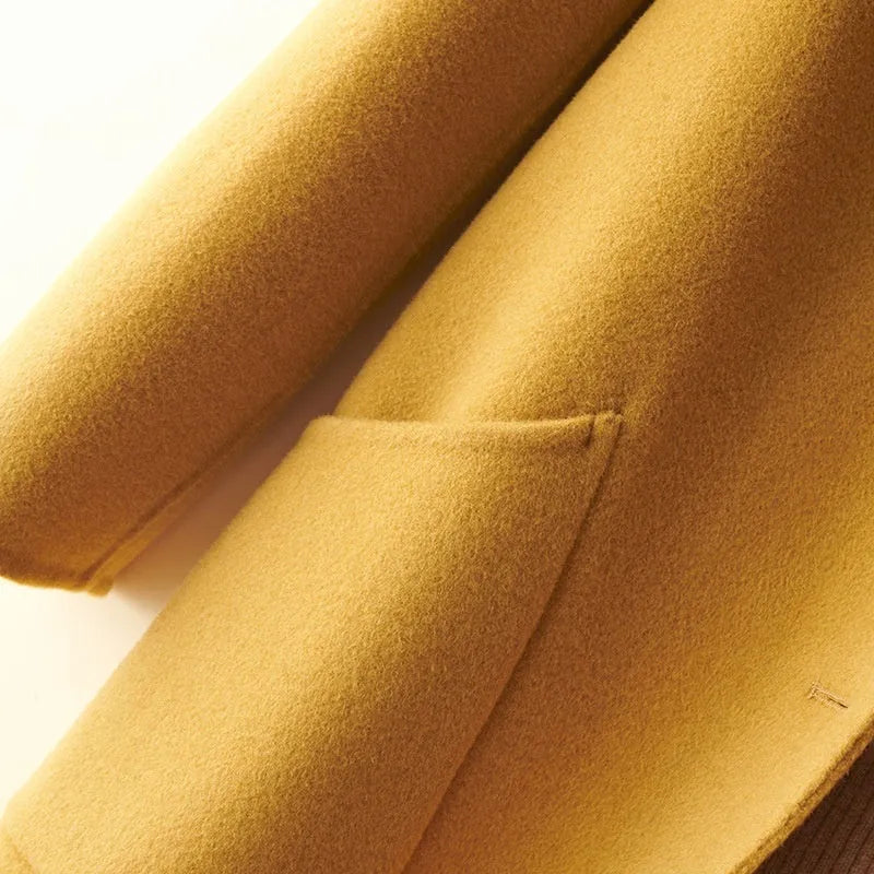 Women's wool double-faced mid-length coat with pearl buckle, doll collar, and front pockets in solid colour