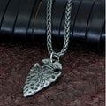 Alloy compass pendant necklace with twisted chain on a flat surface showing silver finish
