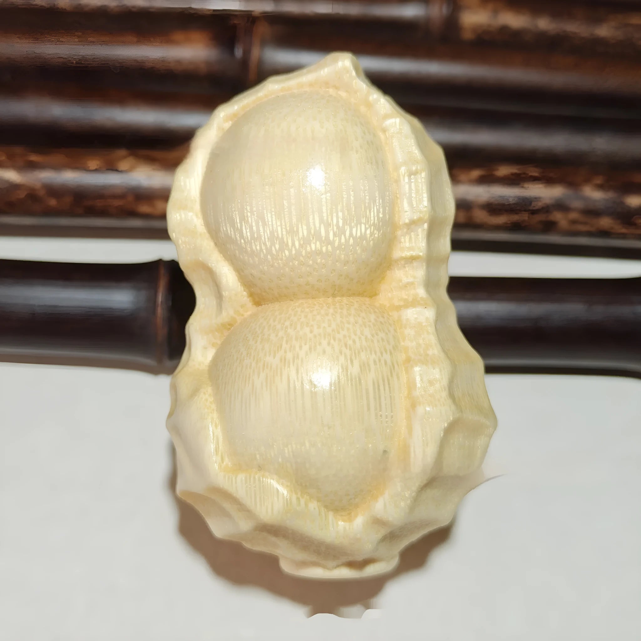 Solid bamboo carved peanut ornament with modern simplicity style and symbolic message.