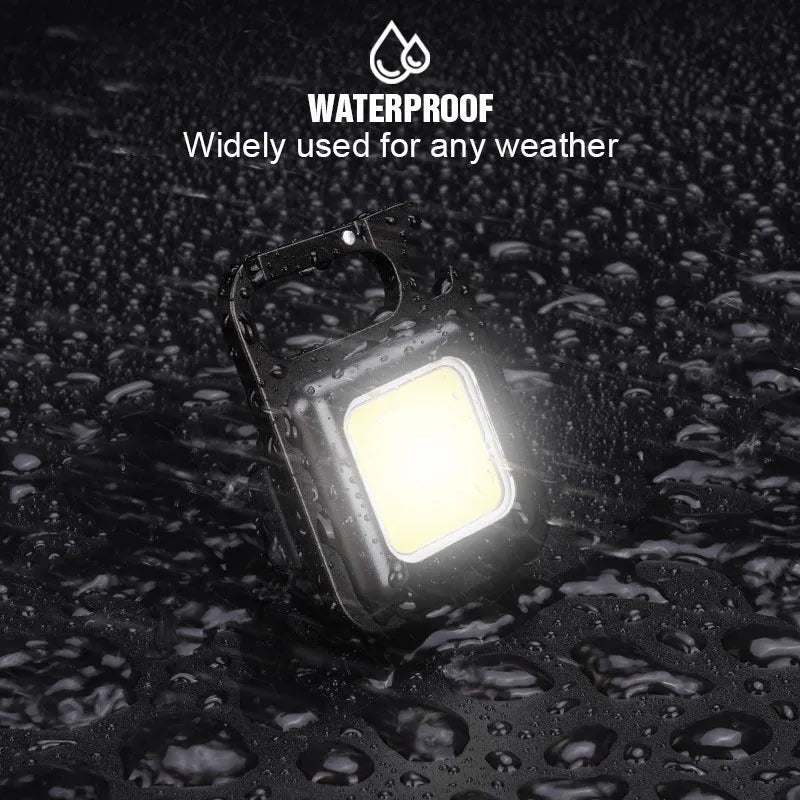 Black aluminium alloy COB keychain light with magnetic base, foldable handle, and key ring, 6x4.2cm