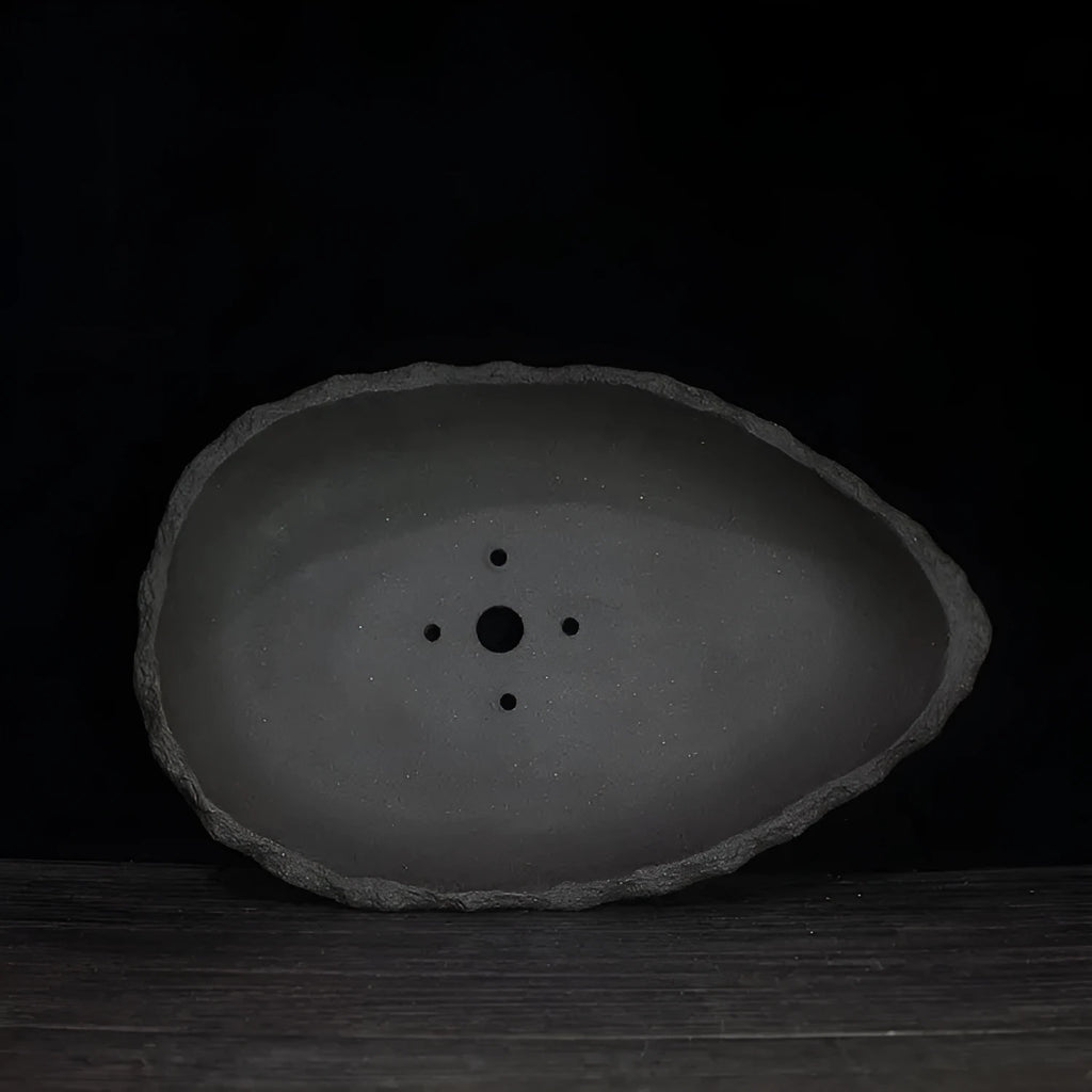 Handmade purple clay flower pot for indoor plants with unique shape and drainage holes