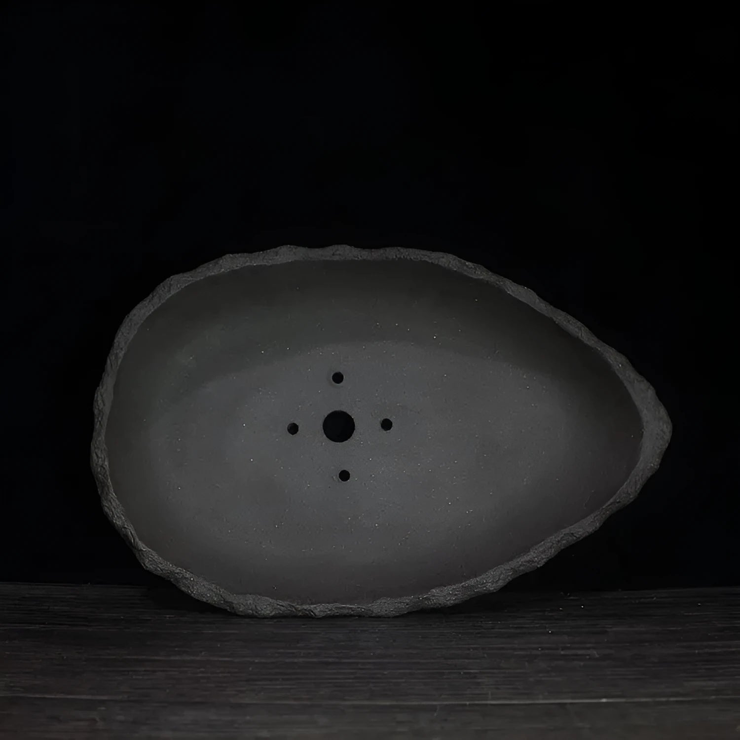 Handmade purple clay flower pot for indoor plants with unique shape and drainage holes