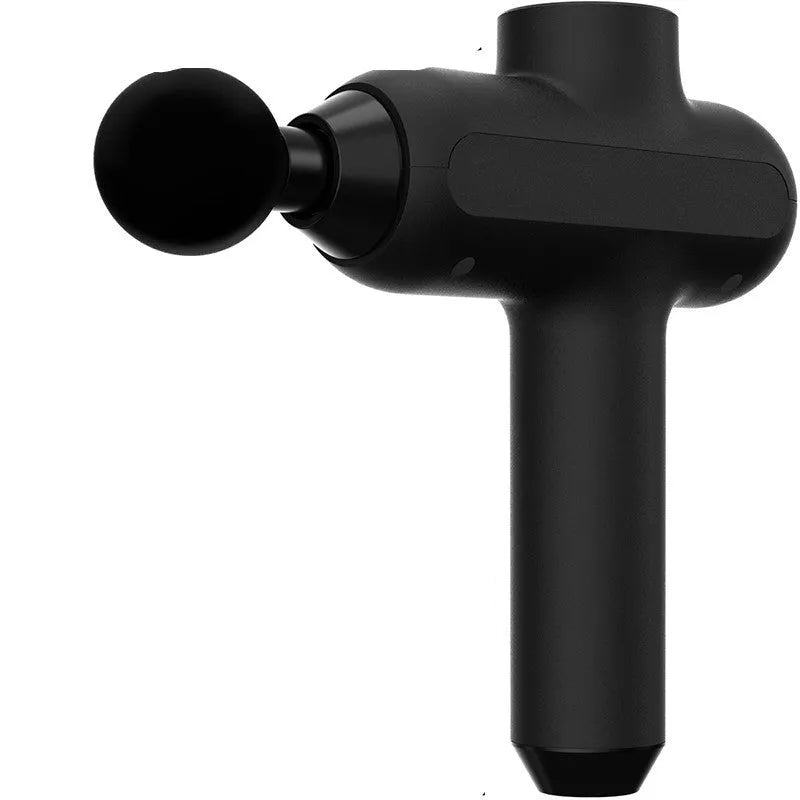 Handheld black muscle percussion massager with six different coloured attachment heads on a table.
