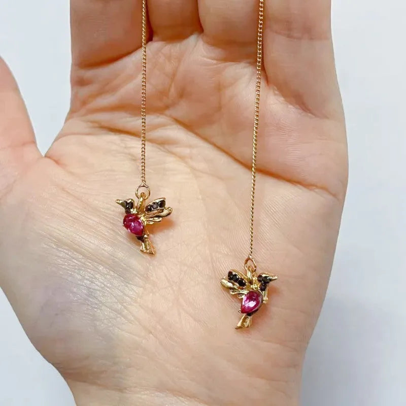 Women's long hanging earrings with bird charm design featuring zirconium wings in blue, red, and red lvzuan colour options
