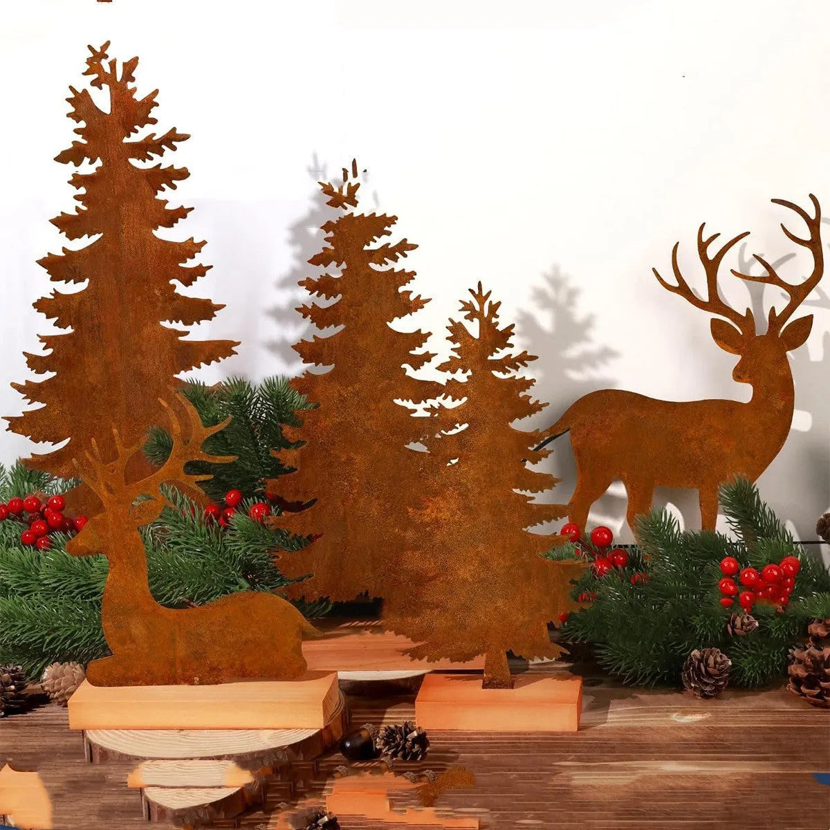 Three rusty metal Christmas decorations with elk and tree designs on white background