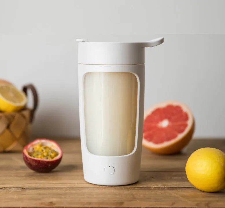 Portable automatic juice blender in black, blue, pink, or white colours showing 650ml capacity markings