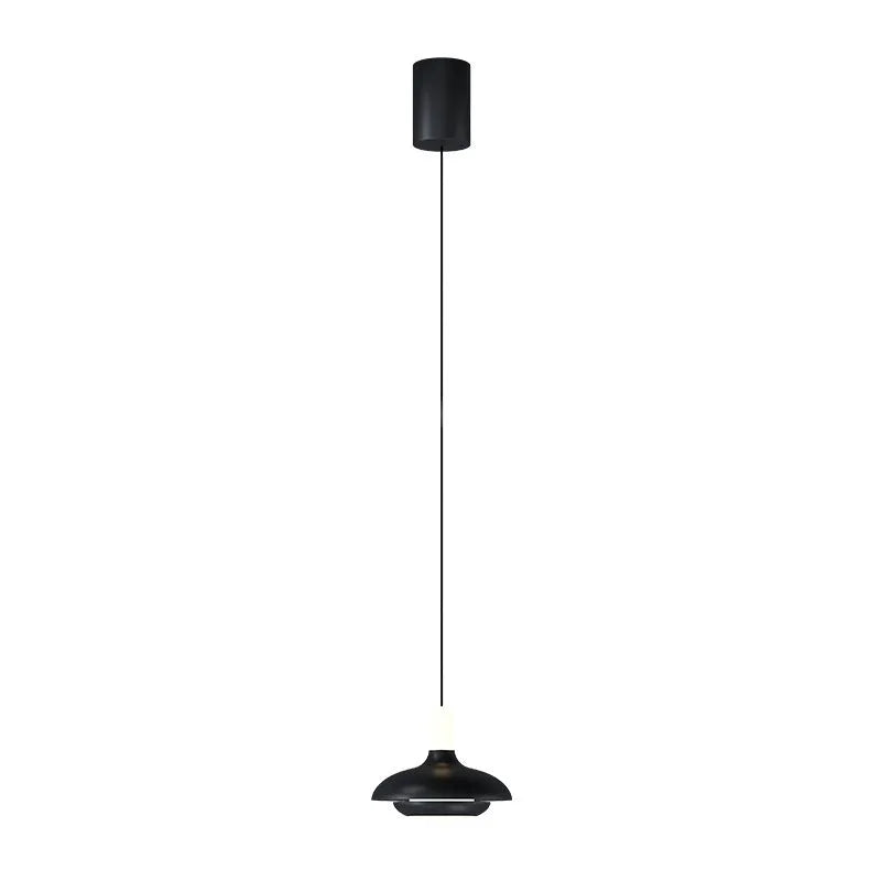 Modern minimalist adjustable bedside pendant light in Moon White shown over a small bedside table