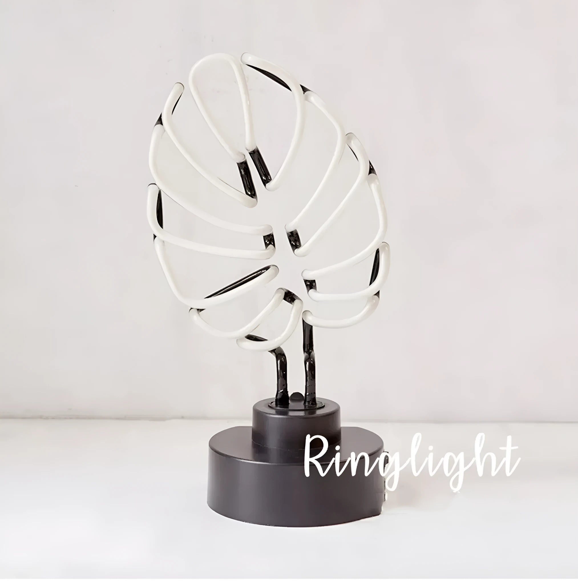 White tube bamboo shape desktop lamp emitting green light, with USB cable.
