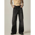 Man's black loose-fit straight-leg jeans with a retro style on a plain background.