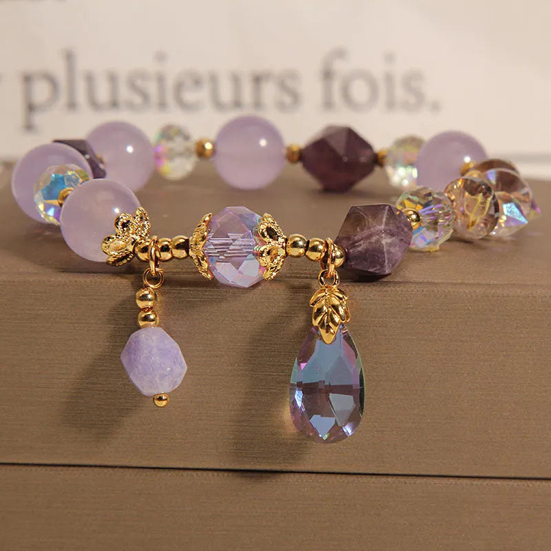 Lavender purple crystal water drop bracelet for children on display, retro original design