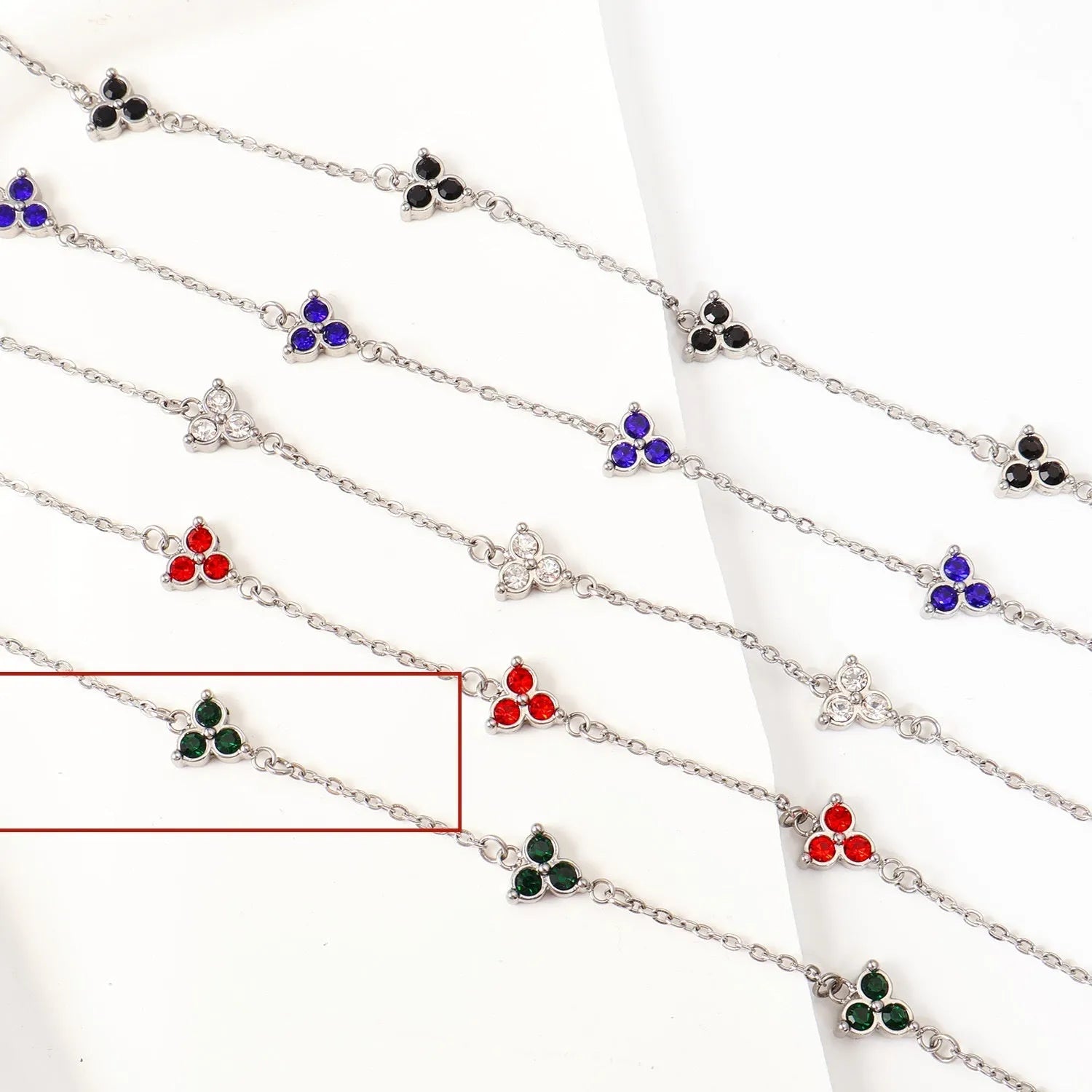 Women's stainless steel bracelet with three triangular diamond charms in geometric design with coloured stones