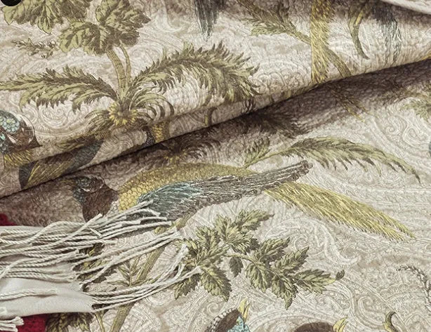 Blue American floral and bird pattern on a pure cotton quilt set with pillowcases, laid on a bed.