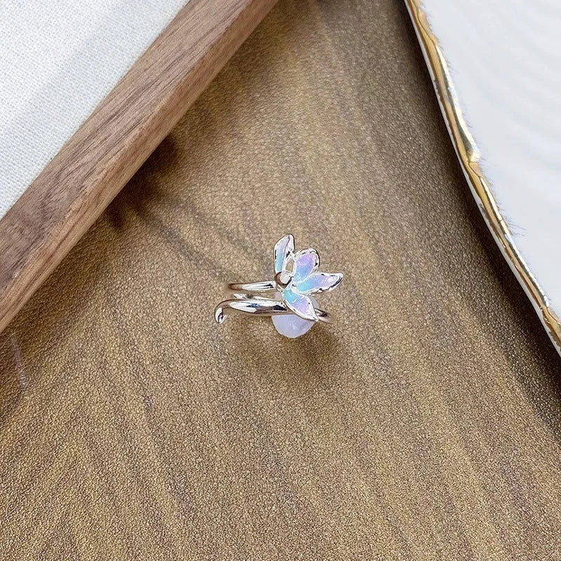 Close-up of an adjustable copper ring with sculptural insect design and a drip-oil texture finish.