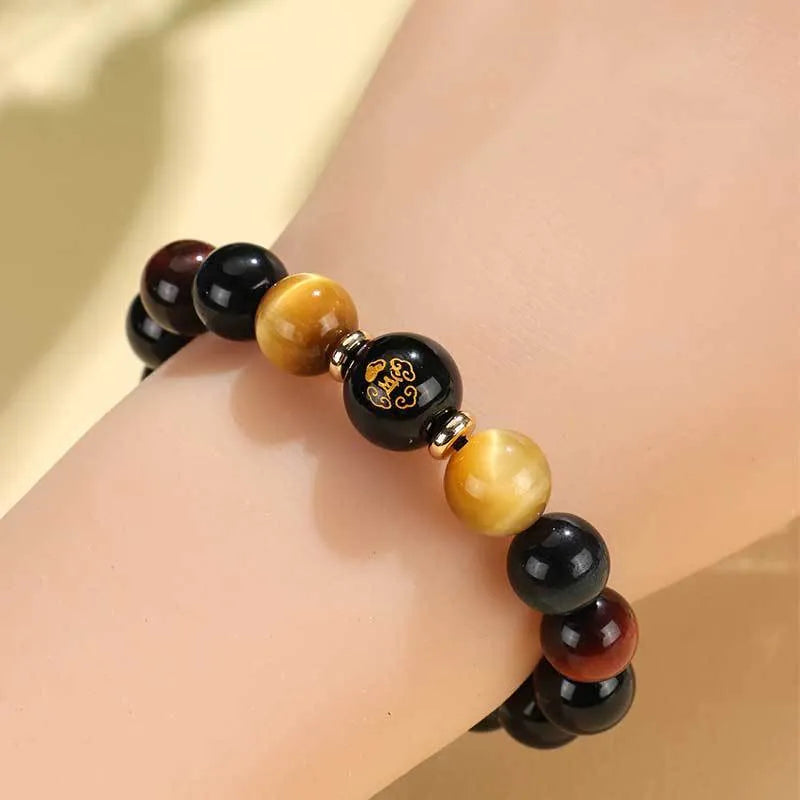 Black agate beaded bracelet with tiger eye stones in ethnic style on plain background
