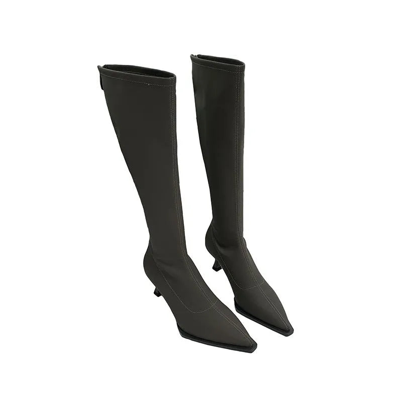 Black pointed toe women's below-the-knee stiletto boots with a back zipper on a white background