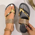 Flat bottom beach sandals with rhinestone toe covering strap in black, gold, and silver colours