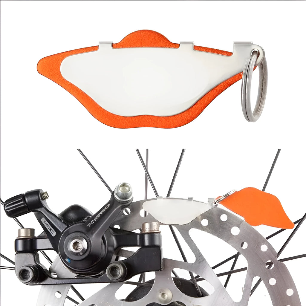 Mountain bike metal disc brake linings in black and orange with adjustment flap