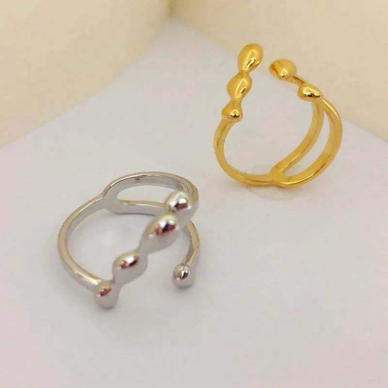 Gold brass opening ring with spherical decorative element on circular band
