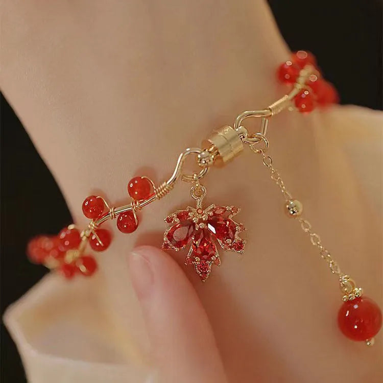 Red ginkgo leaf magnetic bracelet in alloy with electroplated finish on white background