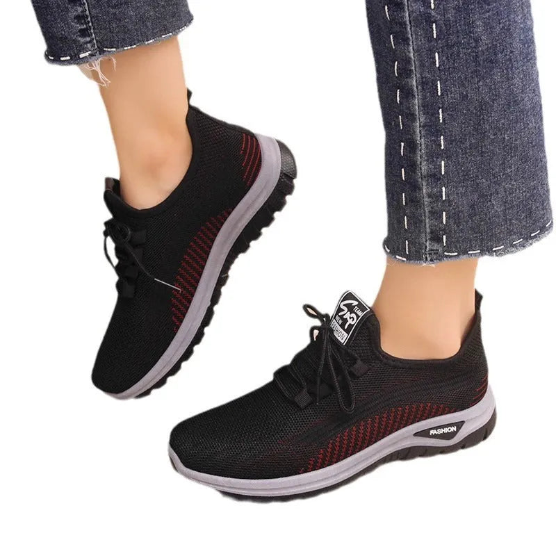 Women's breathable mesh lace-up sneakers with cross straps, round toe, and low heel in black, gray, and purple