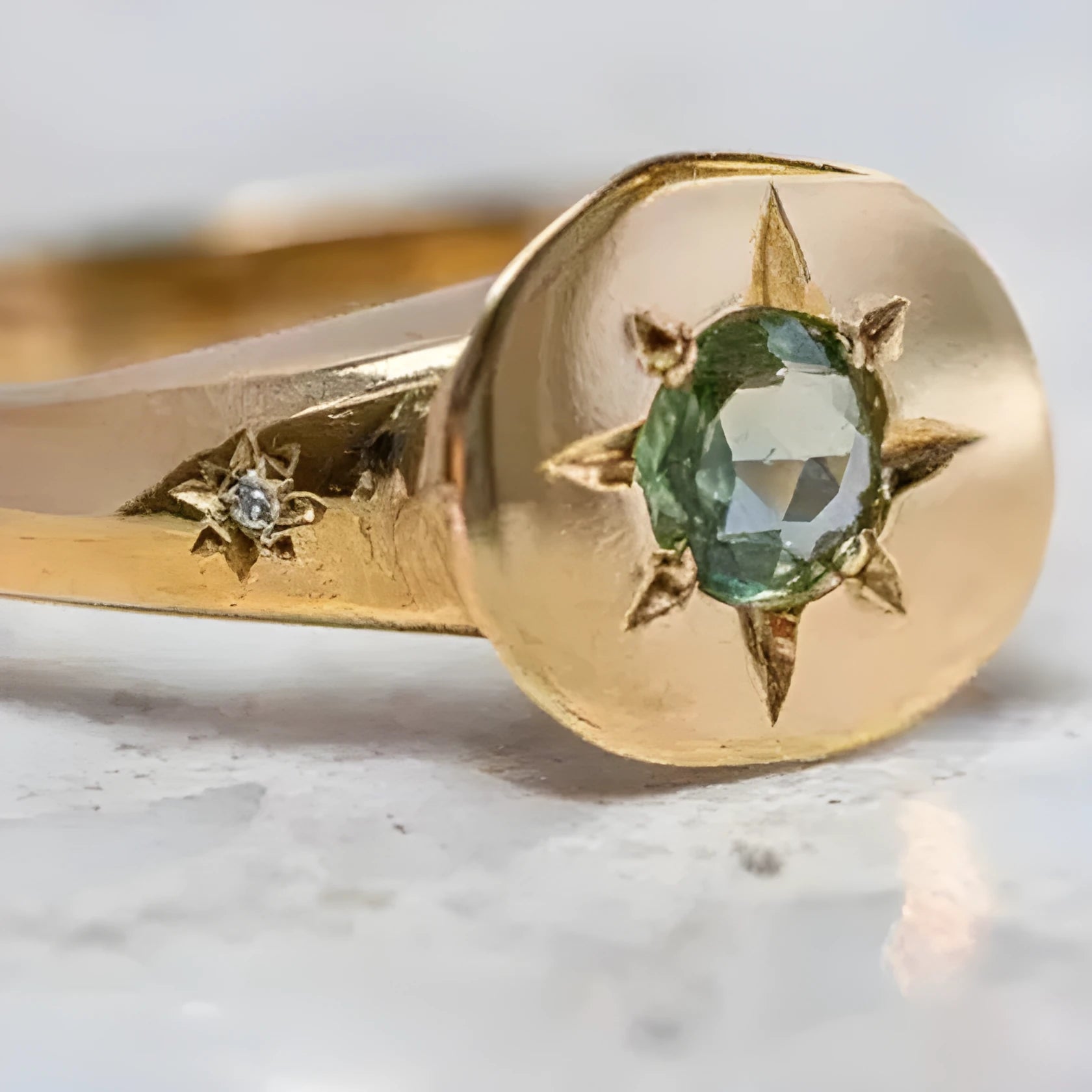 Gold coloured adjustable ring with star-shaped asterism zircon detail and micro inlay treatment