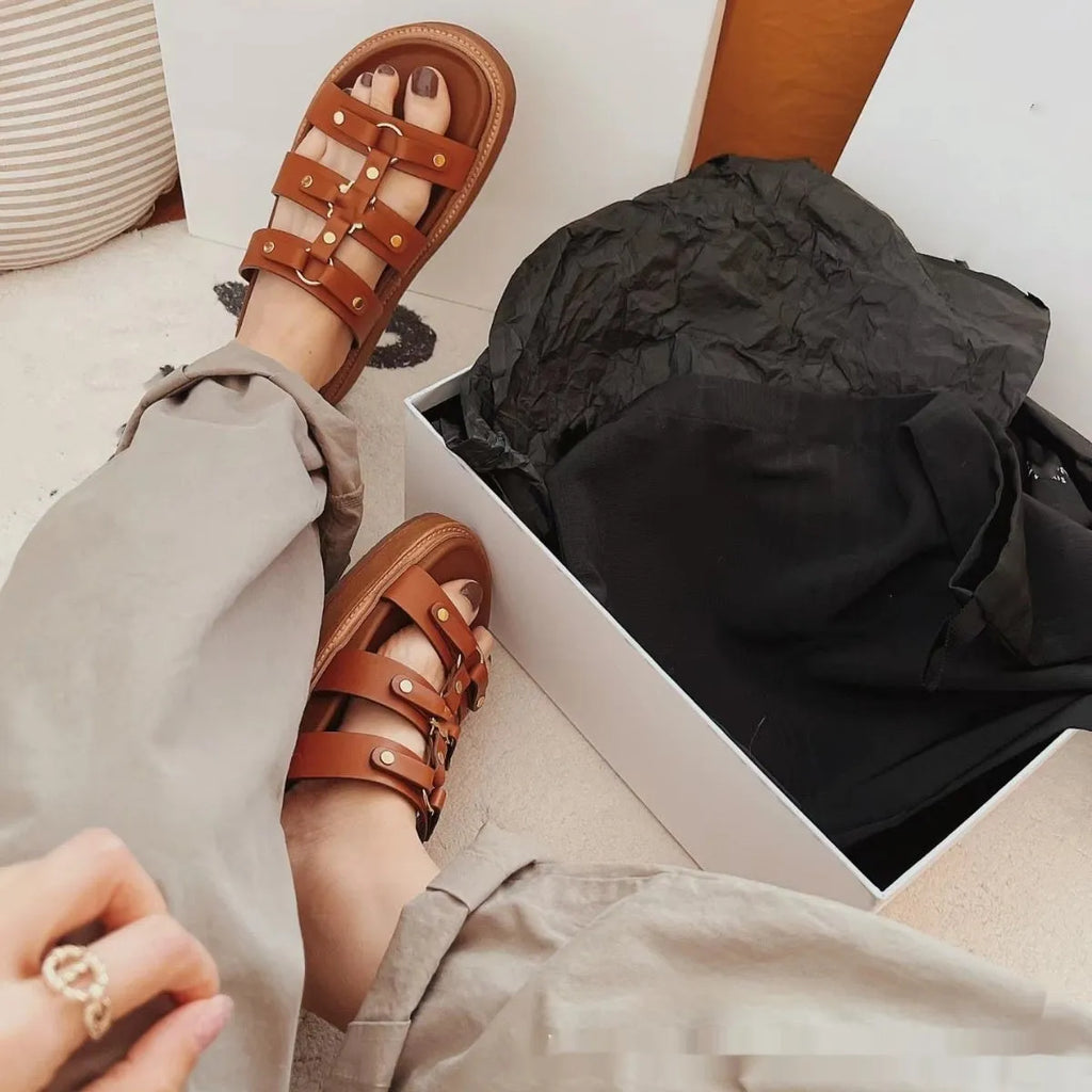 Women's retro Roman sandal slippers in patent leather finish showing strap design