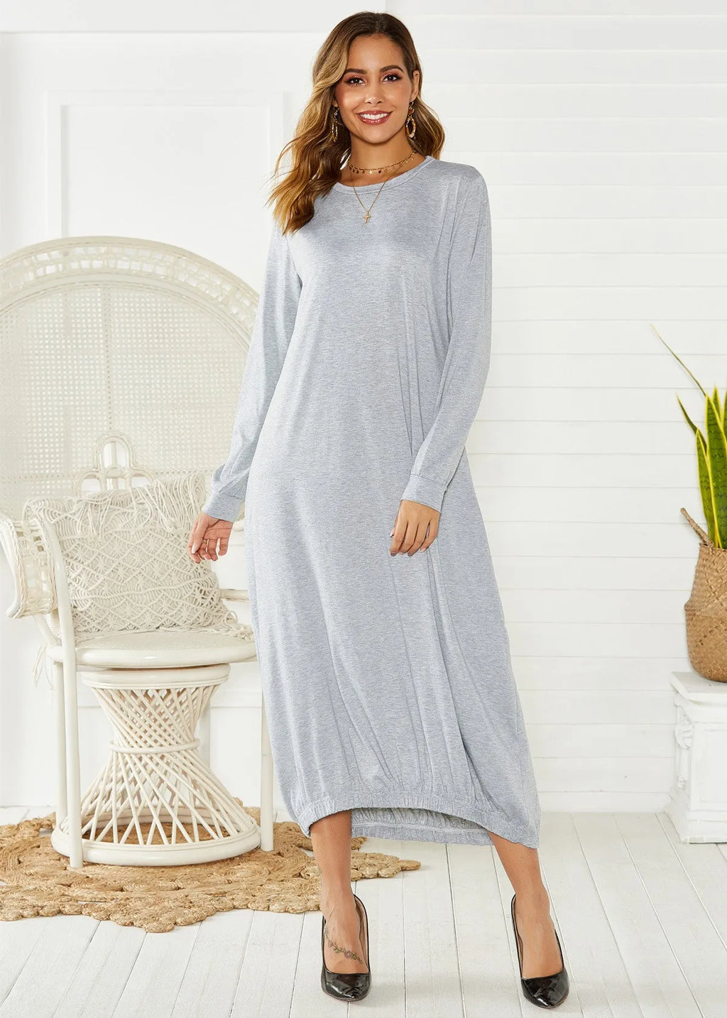 Black lantern dress with lace-up crew neck and loose long silhouette on a hanger.