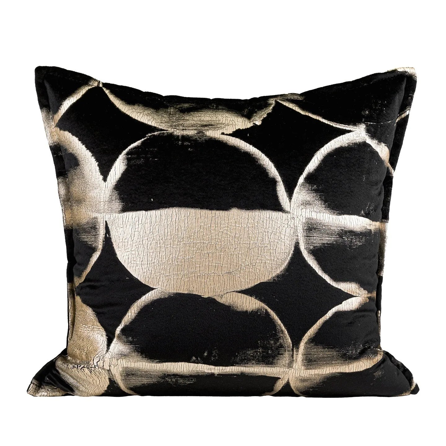 Black and gold abstract patterned decorative flannel cushion on a grey sofa.