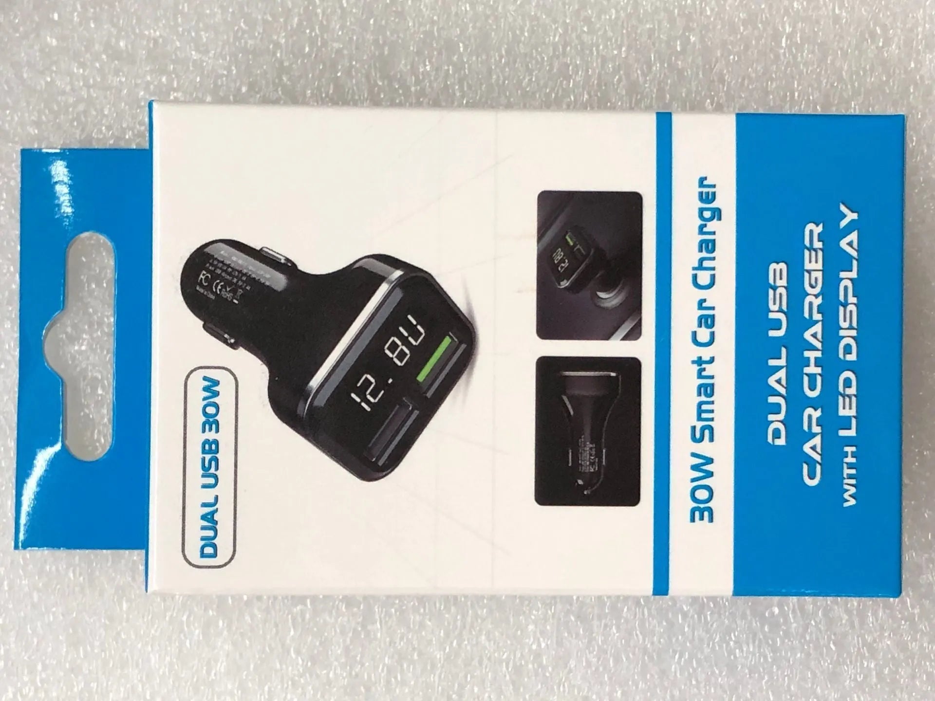 Black car charger with LCD display showing voltage reading, dual USB ports, PC+ABS construction