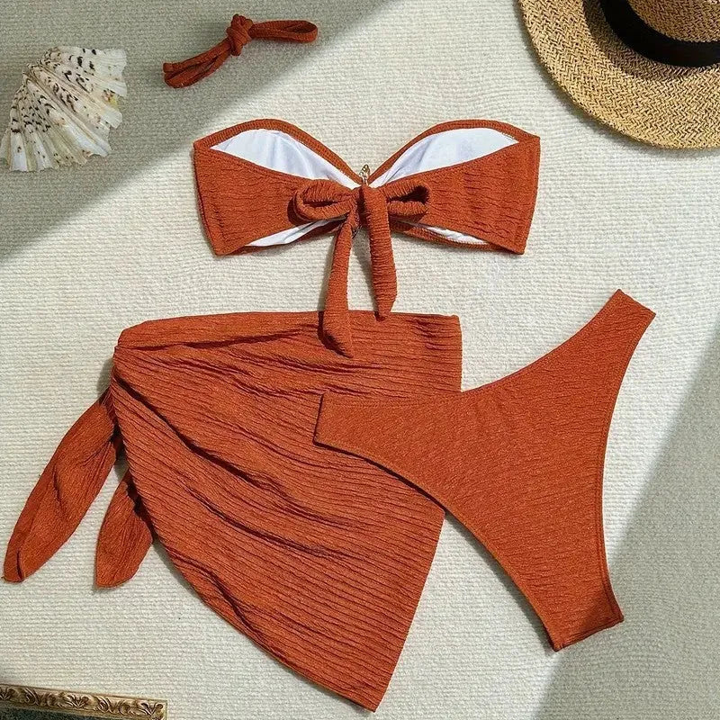 Brown floral three-piece swimsuit set with tube top, pants, and skirt on a model