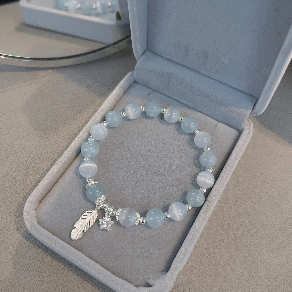Small white girl crystal bracelet in feather XINGX blue moonlight with eight Awn star motif on wrist