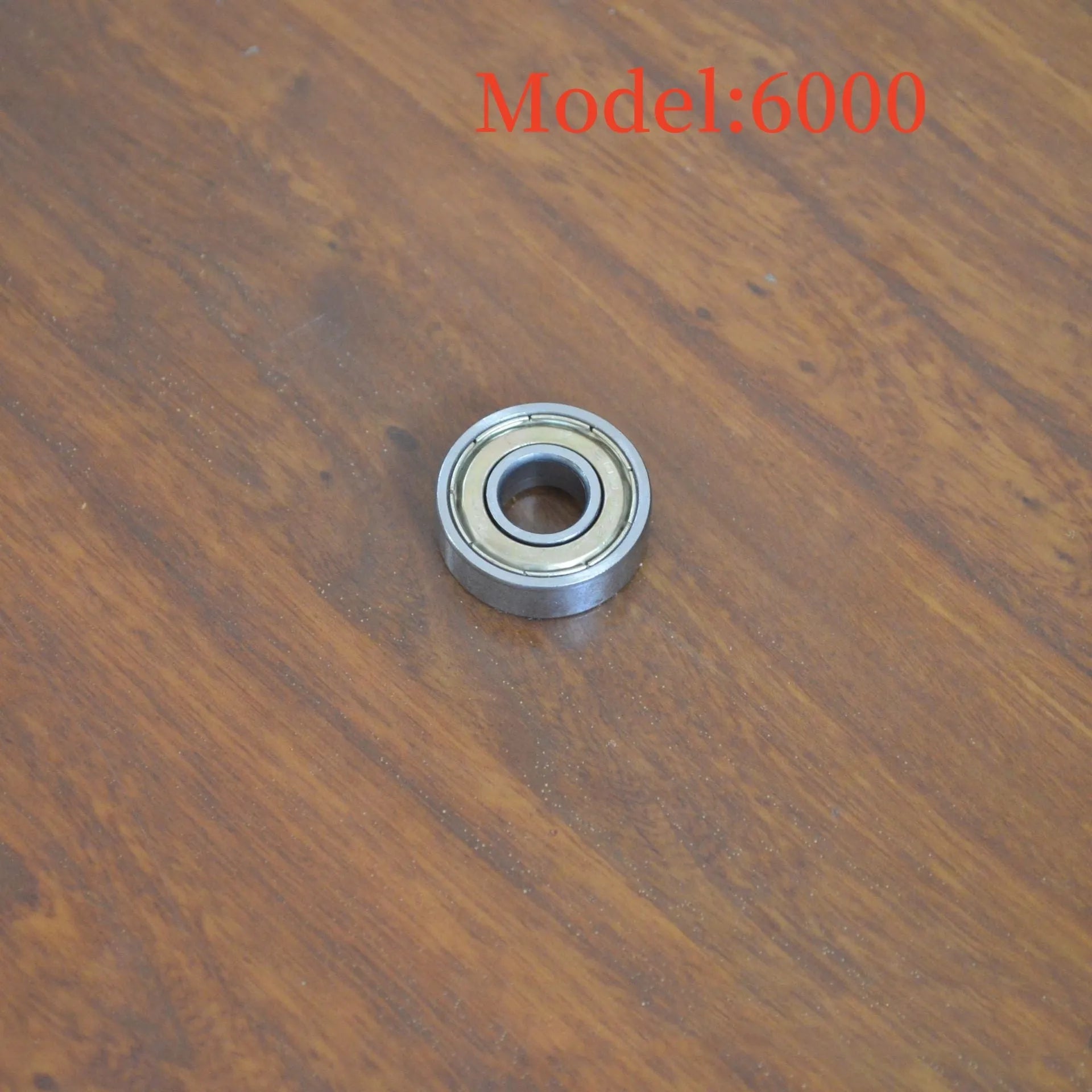 Carbon steel bearing 6000zz with dimensions 10x26x8mm on a white background