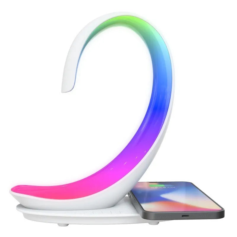 White swan-shaped desk lamp with wireless charging pad and Bluetooth speaker, showing colourful LED lights.